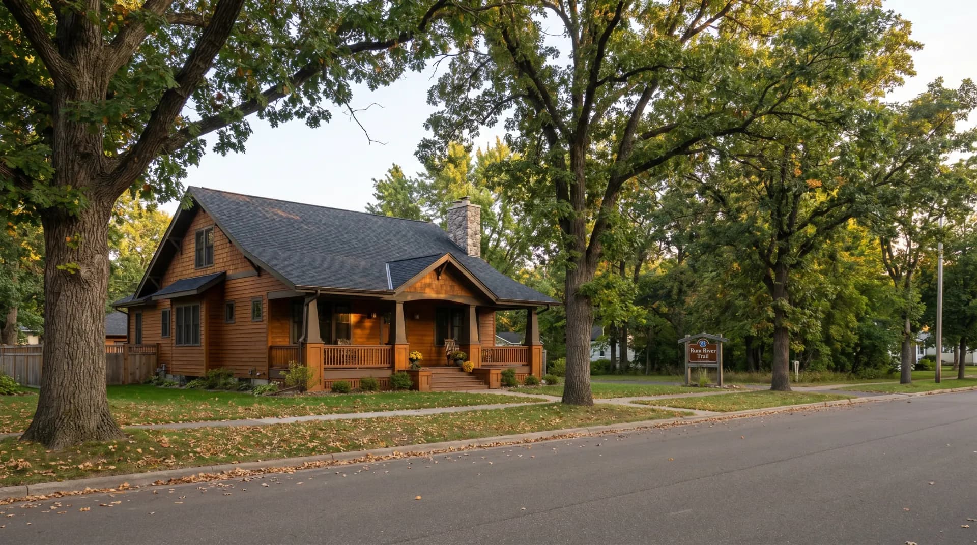 Residential home in Minnesota being re-roofed — contractor installing new asphalt shingles on a steep-pitched roof